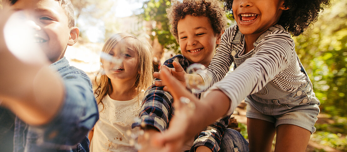 Kids playing with soap bubbles adventure